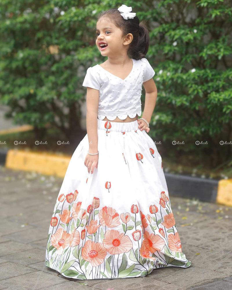 White Scallop Top With Pearl Beads, Paired With A Floral Poppy Print Skirt