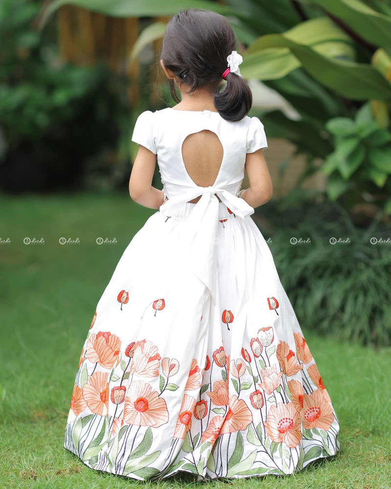 White Scallop Top With Pearl Beads, Paired With A Floral Poppy Print Skirt