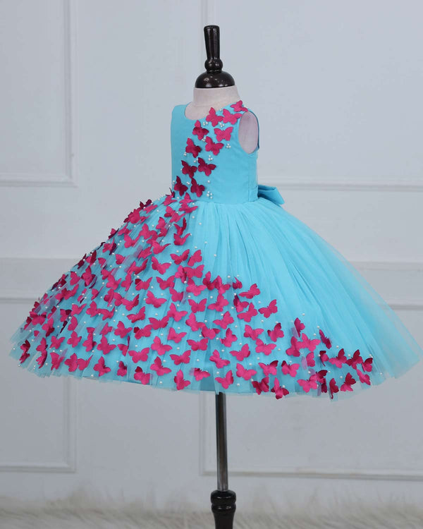 Aqua Marine Blue Partywear Frock with Spreaded Rani Pink Butterflies