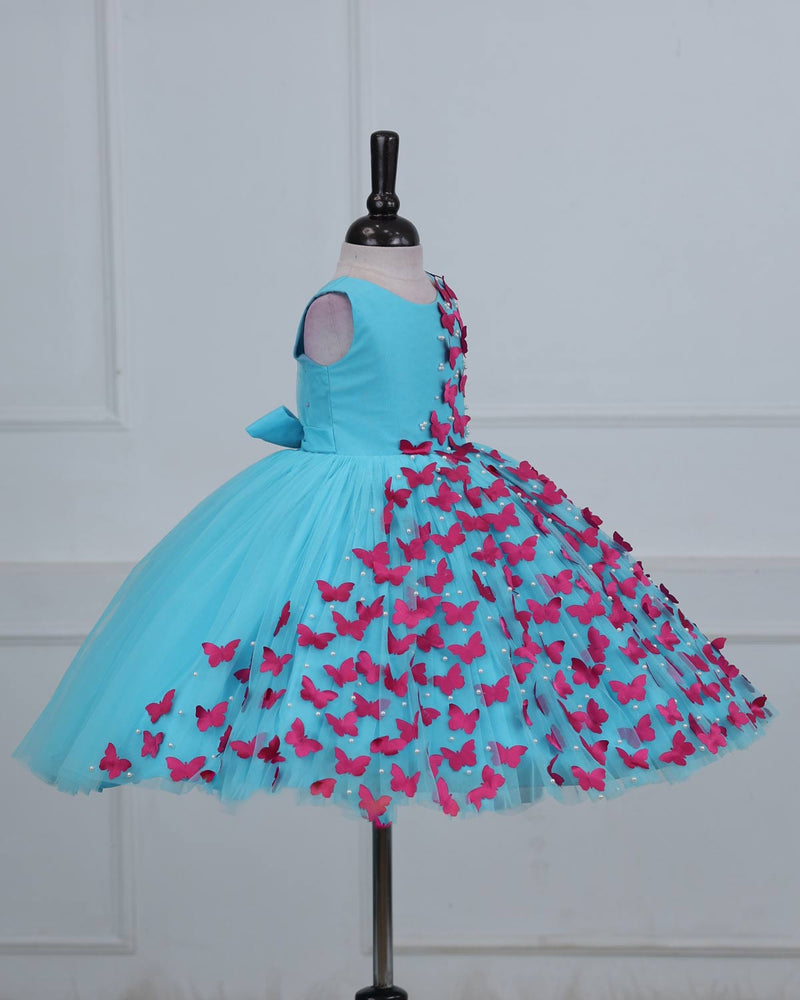 Aqua Marine Blue Partywear Frock with Spreaded Rani Pink Butterflies