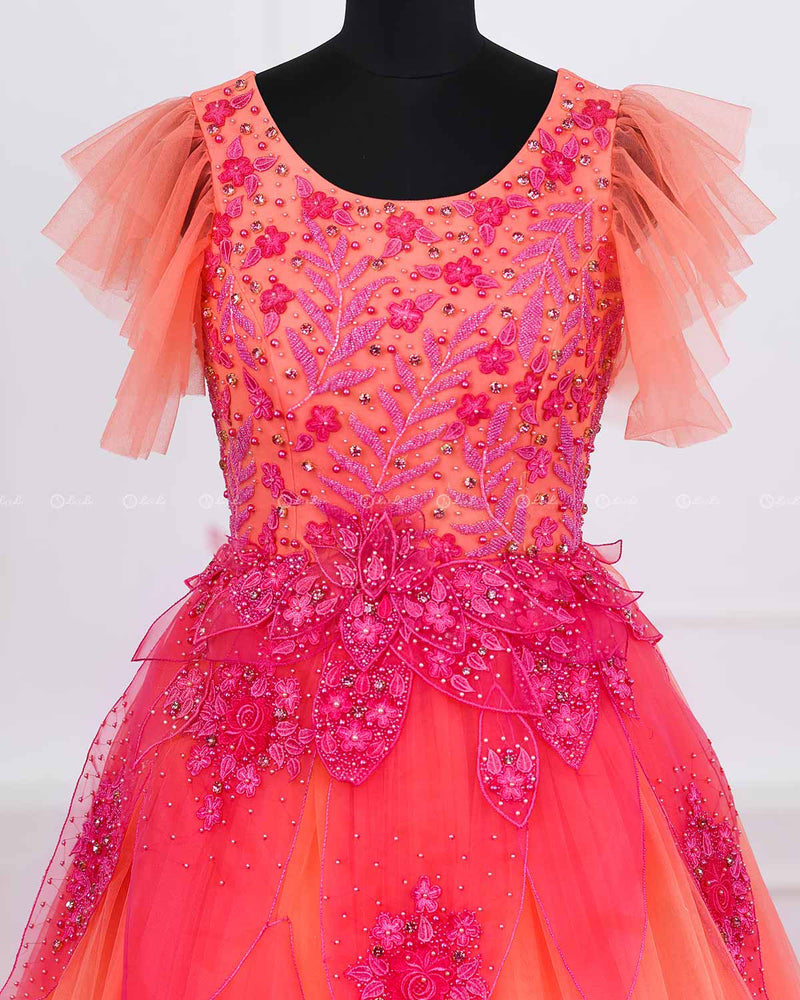 Coral and fuchsia pink designer gown with applique flowers and bead work detailing