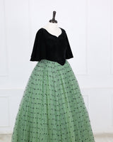 Dark Forest Green velvet sweetheart gown with flowy sleeves and a mint heart-mesh flare.