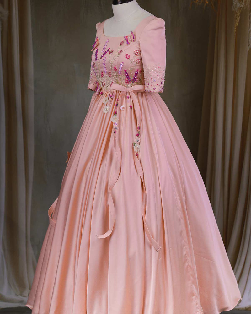 Butterfly and Floral Theme Peach Gown with Attached Bows and Applique Works.