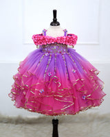 A Dreamy Cold-Shoulder Ball Gown with Flowing Layers of Lavender and Pink Tulle.