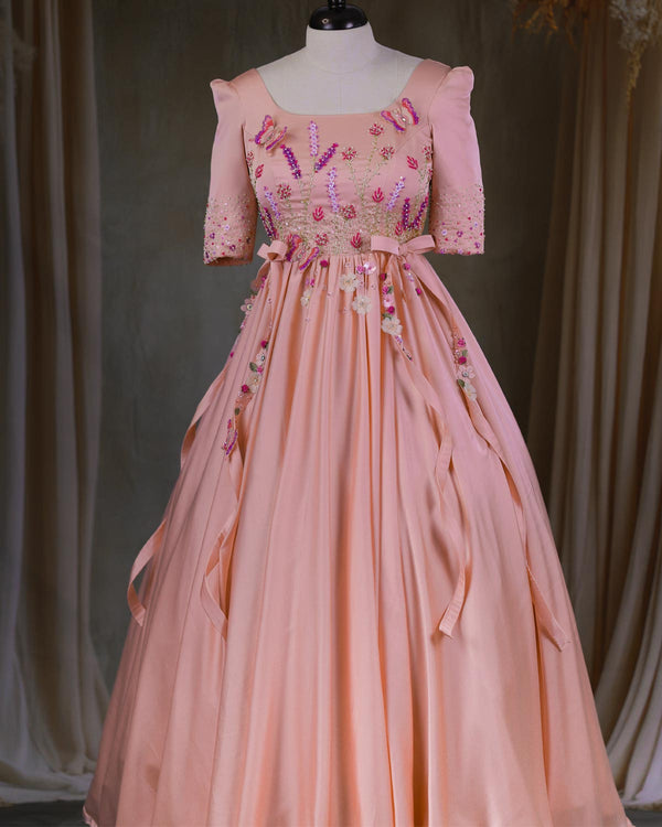 Butterfly and Floral Theme Peach Gown with Attached Bows and Applique Works.