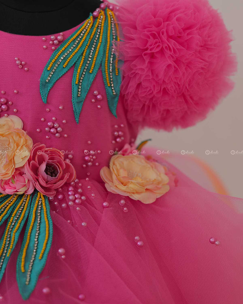 Flamingo Pink Twirled Gown Embellished with Artificial Flowers  and Greenish Blue Petals