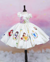Enchanting hand-painted frock featuring princesses and a fairytale castle—perfect for a magical occasion.