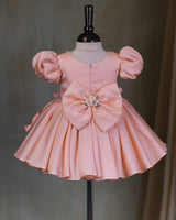 Butterfly and Floral Theme Peach Frock with Attached Bows in waistline and Applique Works.