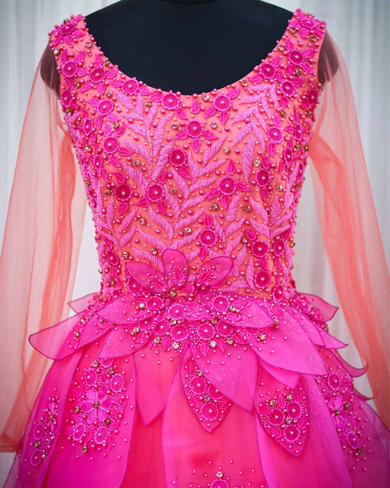 Coral and fuchsia pink designer gown with applique flowers and bead work detailing